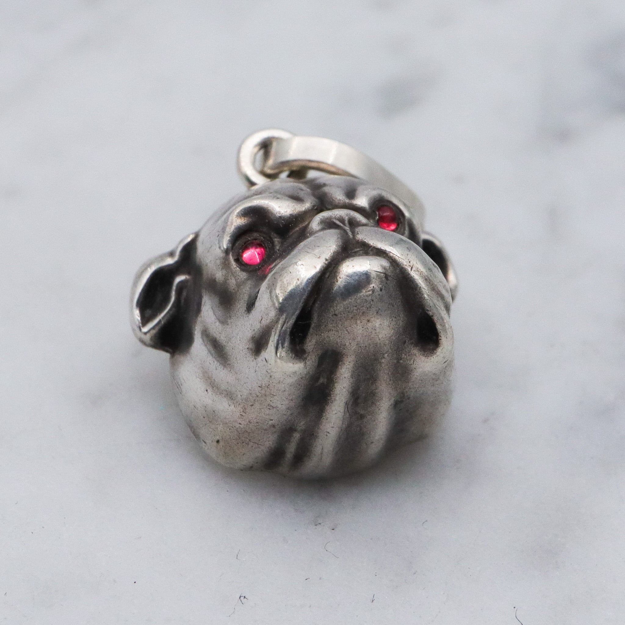 Antique Unger Brothers sterling silver bulldog with ruby glass eyes pendant